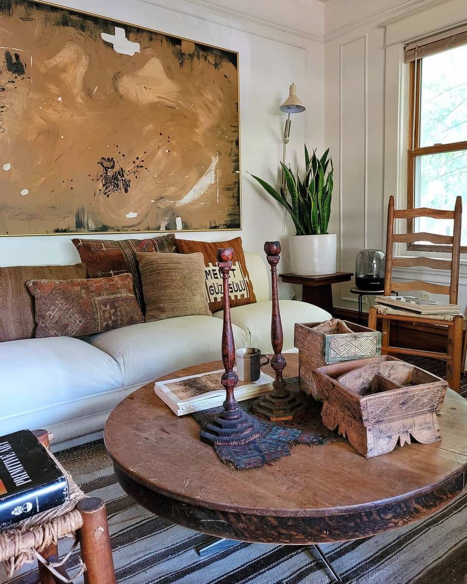 Cozy living room with a brown couch, abstract painting, rustic coffee table, and wooden decor accents