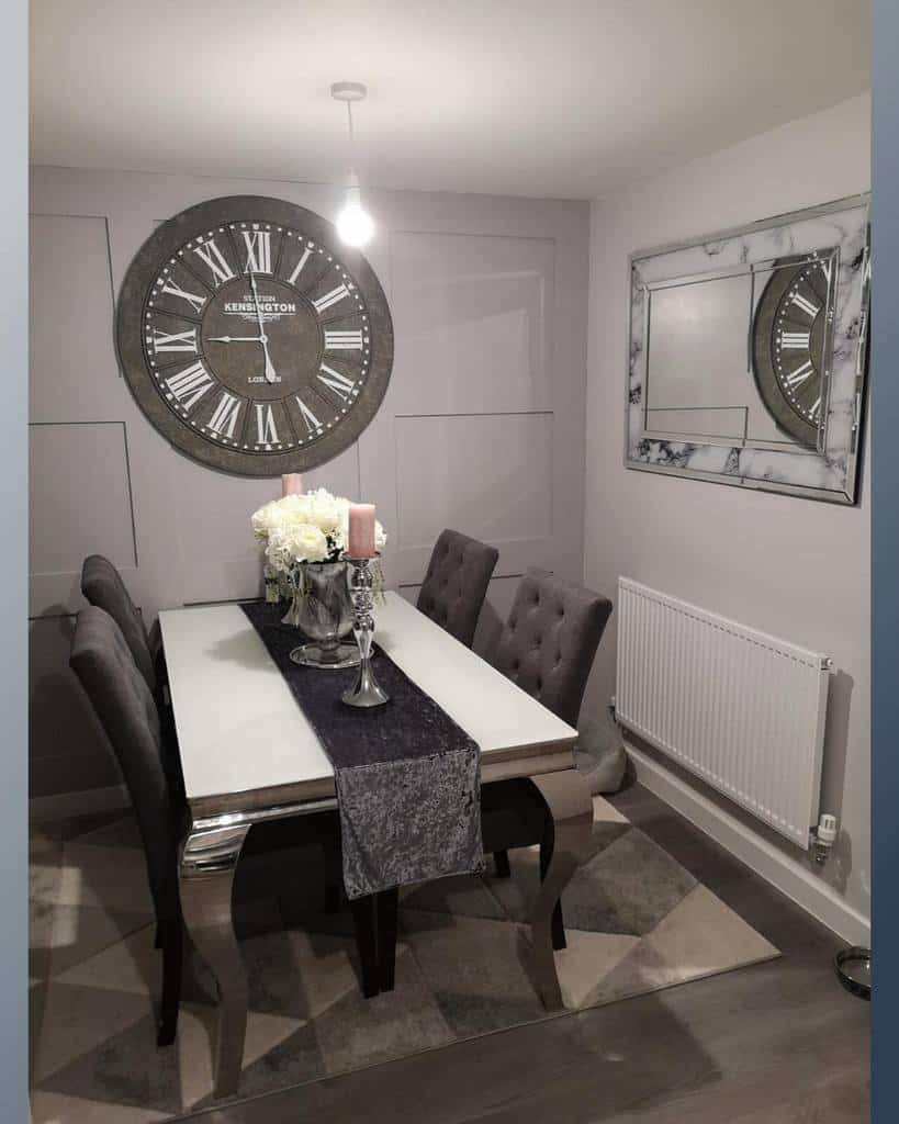 dining room with large wall clock and mirror 