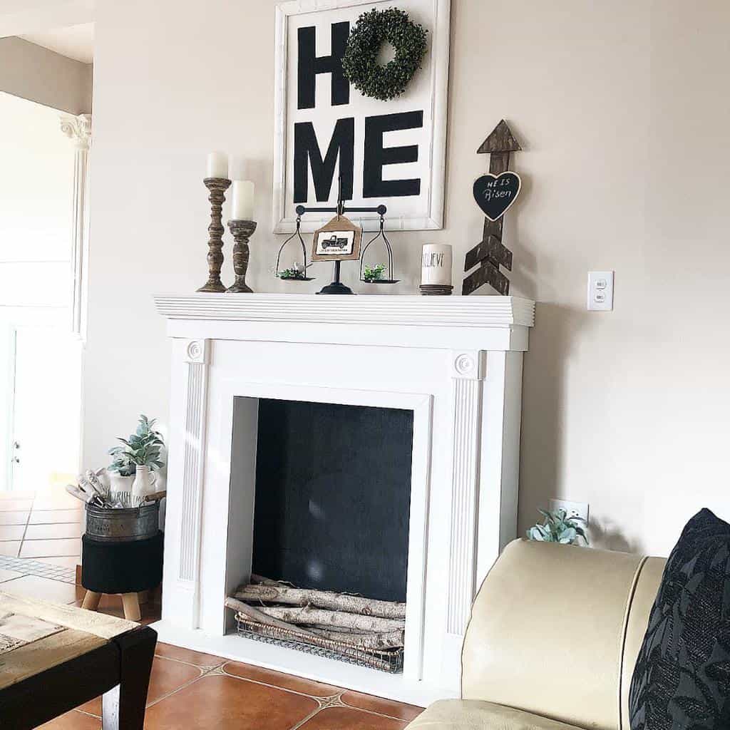 living room white fireplace mantle with candlesticks and scales home wall art