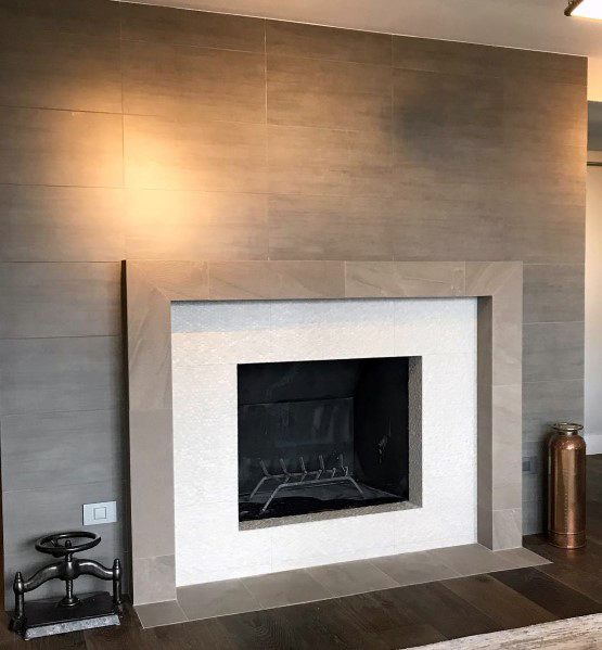 Modern fireplace with beige tile surround and textured white tile interior.