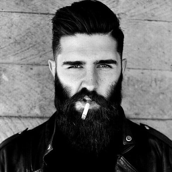 Man with long black beard smoking