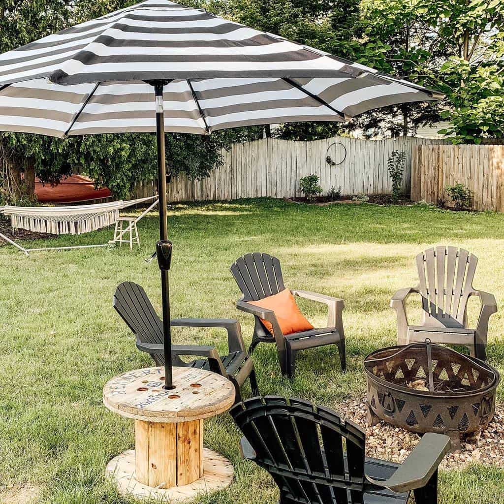 backyard fire pit black chairs umbrella hammock