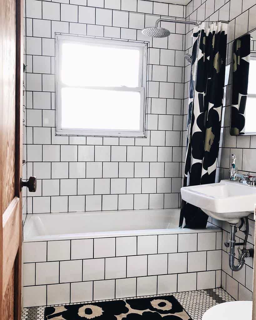 white wall tile bathroom with shower/bath combo 