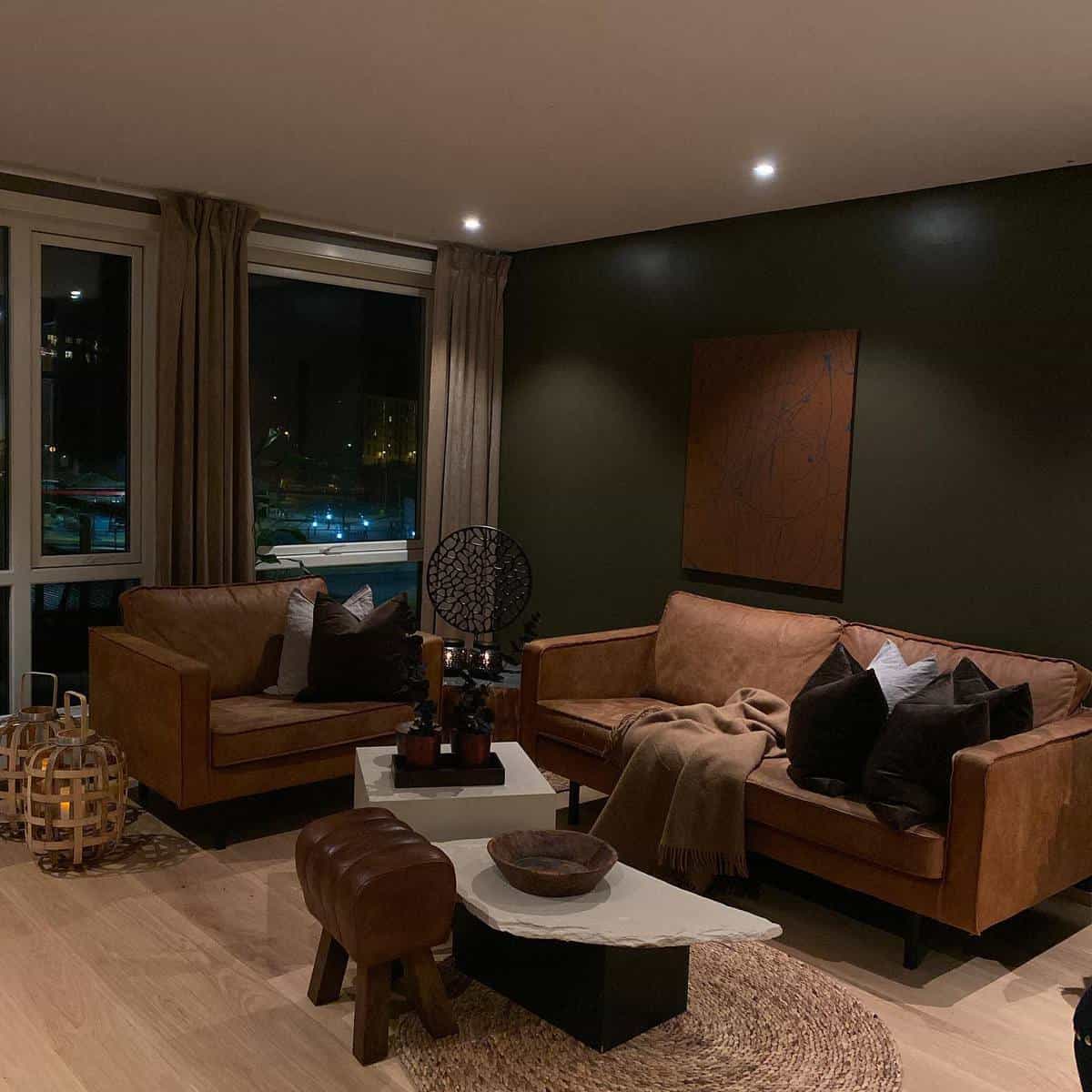 Cozy brown living room at night with sofas, a coffee table, wall art, and decorative pillows