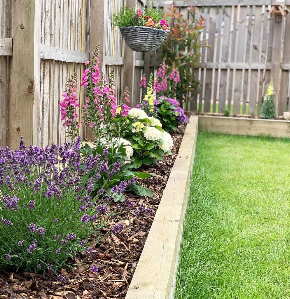 wood edge garden flowers grass wood fence