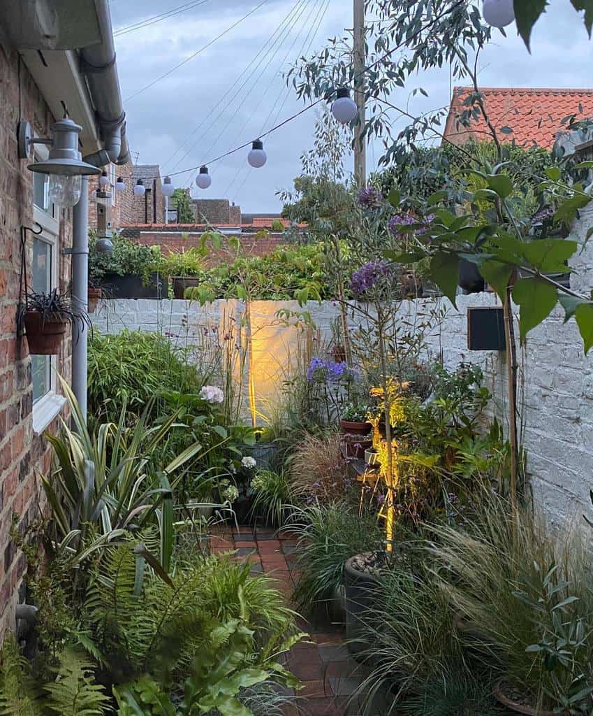 corner backyard garden with brick paver walkway