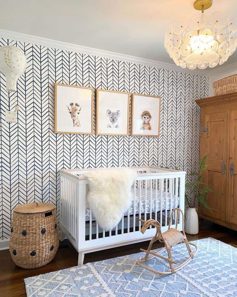 Baby room with white crib, wicker rocking horse, animal wall art, and chevron-patterned wallpaper.