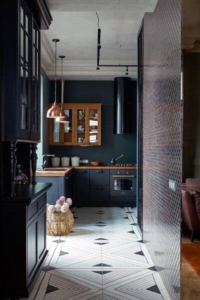 Stylish kitchen with black cabinetry, copper pendant lighting, and a bold geometric tile pattern on the floor