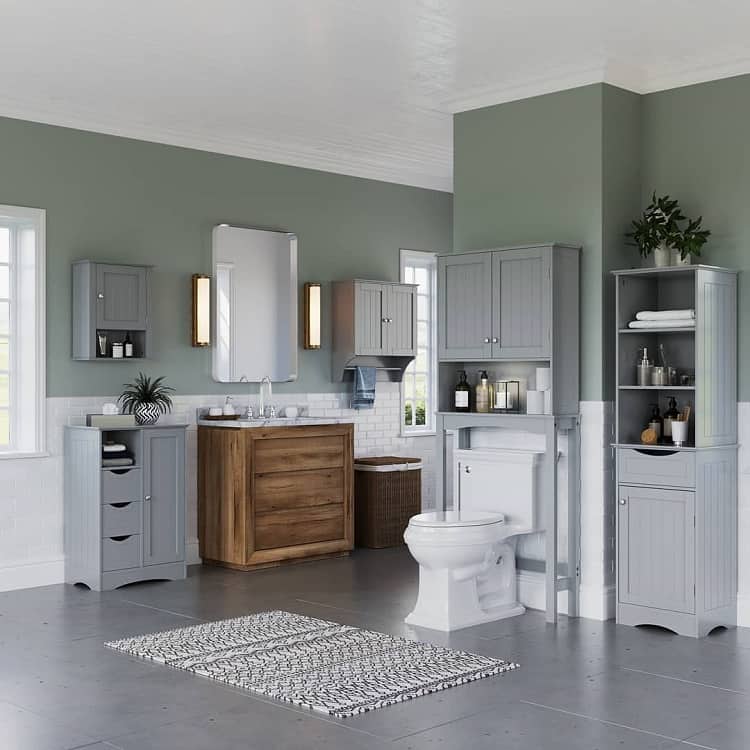 Large country-style bathroom with grey cabinets, wooden vanity, and green walls.