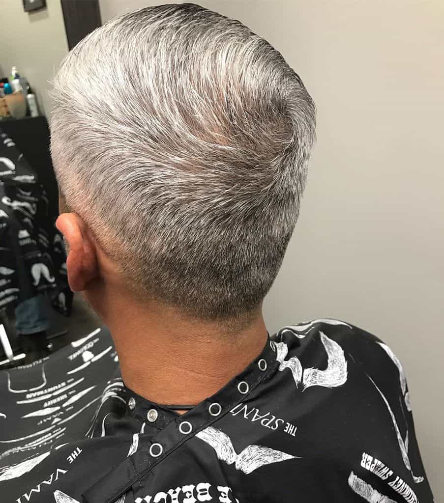 A crew cut hairstyle for guys with gray hair. It features slightly longer hair on top and faded sides