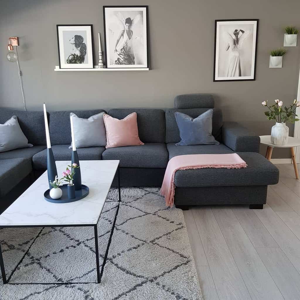 Chic living room with a gray sectional sofa, pastel cushions, marble coffee table, and stylish black-and-white wall art