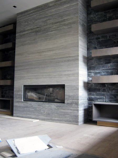 Modern fireplace with gray horizontal tiles, linear gas insert, and surrounding stone accent walls.