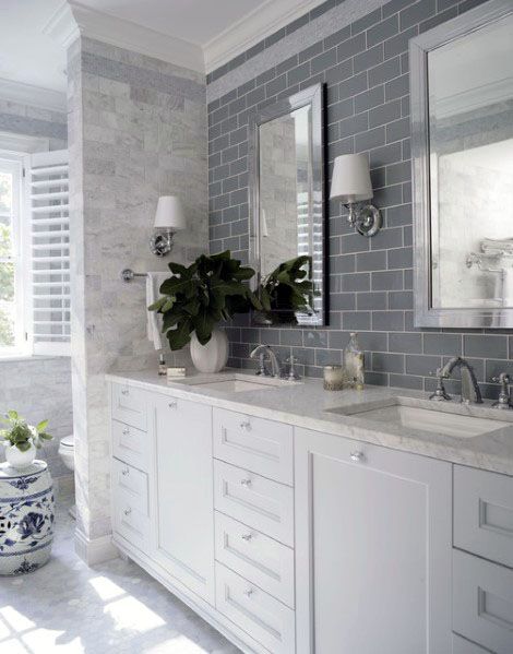 Bathroom with grey beveled subway tile backsplash, white vanity, and chrome fixtures.