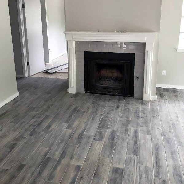 Gray subway-tiled fireplace with a white mantel in a modern living room.