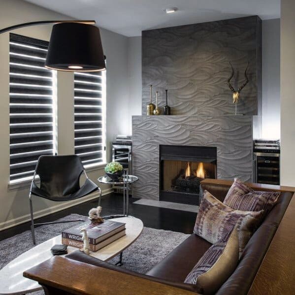 A contemporary fireplace with gray wavy-patterned tiles, adding a textured and artistic touch to the cozy living room.