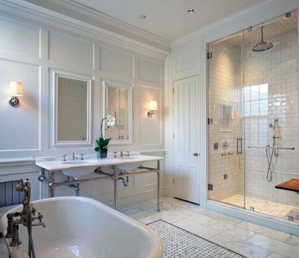 Spacious vintage bathroom with freestanding tub, double sink, and glass shower enclosure.