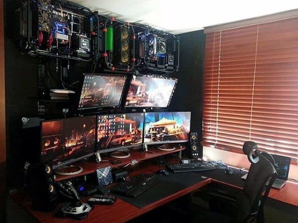 High-tech gaming setup with multiple monitors and custom PC components mounted on wall