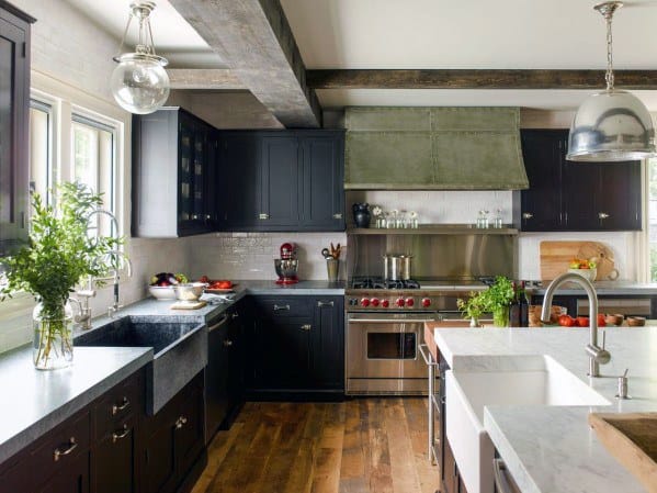 Rustic black kitchen cabinets with wooden beams, farmhouse sinks, and marble countertops.