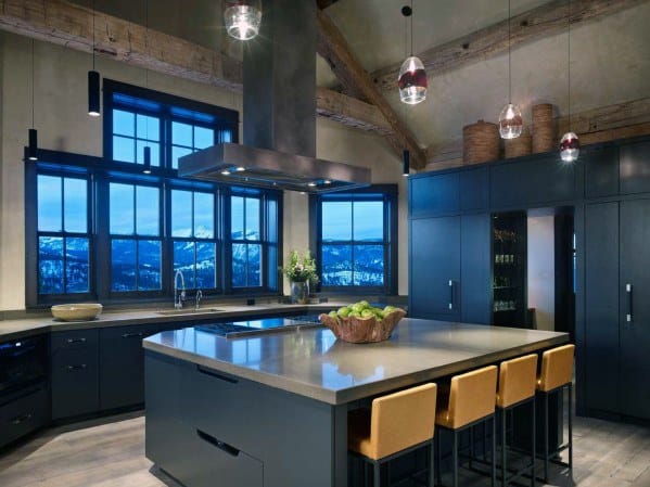 Contemporary black kitchen with large island, mountain view windows, and pendant lights.