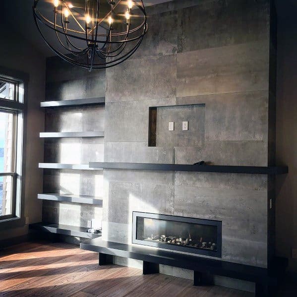 A sleek modern fireplace with large concrete-style tiles, complemented by minimalist floating shelves for a bold industrial look.