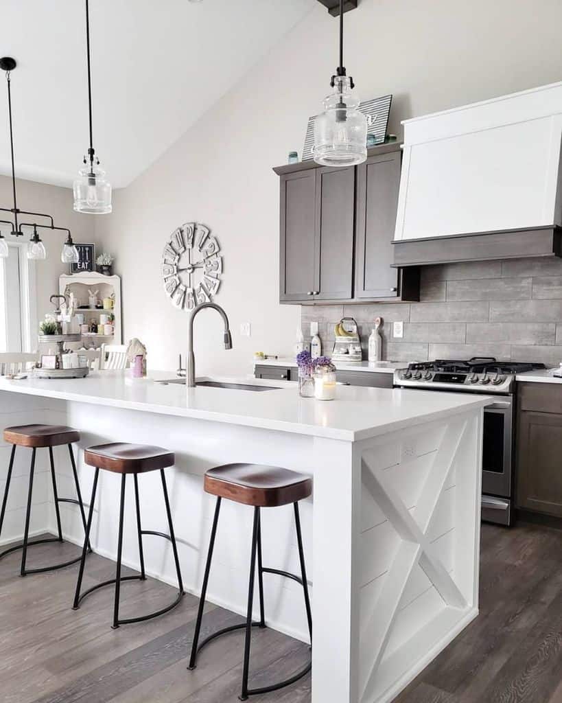 white country kitchen gray tile backsplash white countertop wood stools 