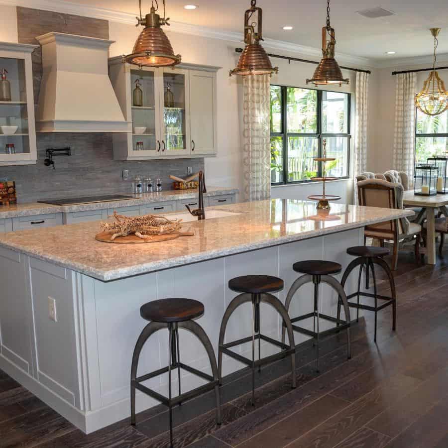 industrial kitchen marble countertop wood stools pendant lights 