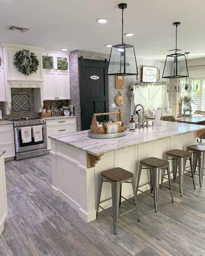 large white cabinet kitchen with gray wall tiles and barn doors