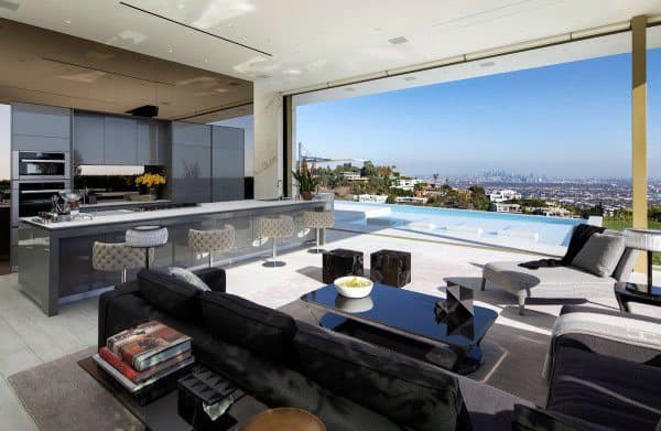 Luxurious open-plan kitchen and living room with a city view and infinity pool