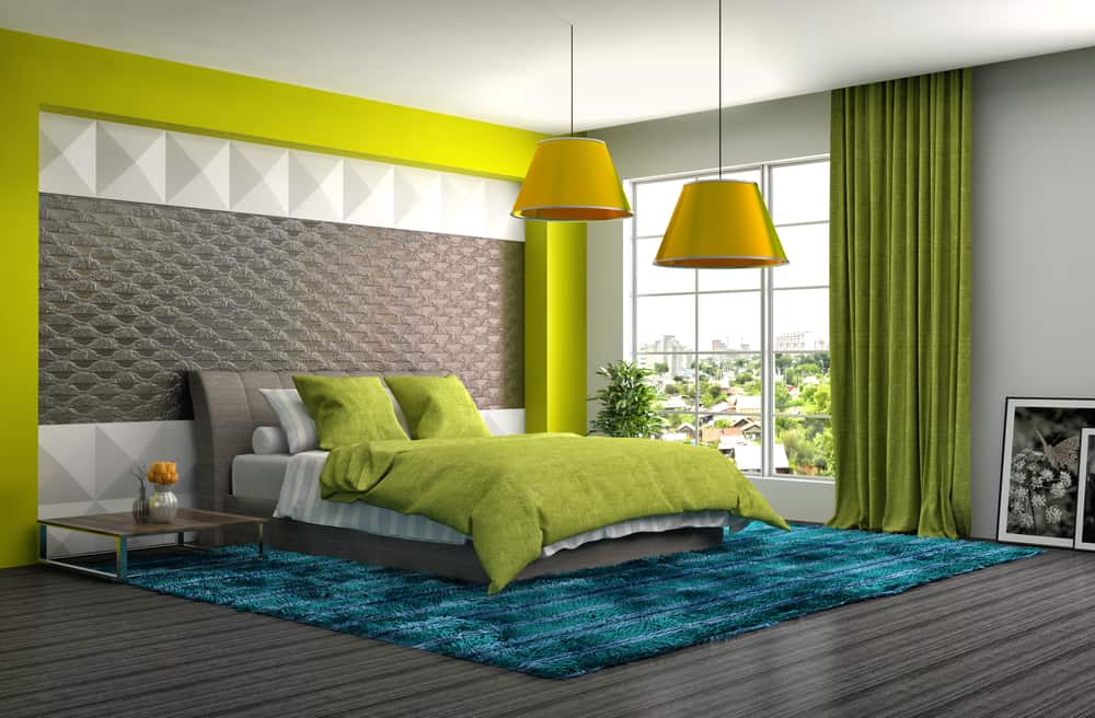 Modern bedroom with green accents, including bedding and curtains, features a textured wall and large windows