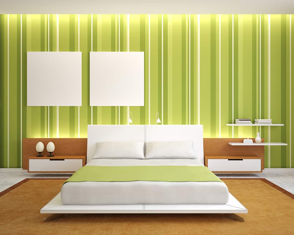 Modern bedroom with a green striped wall, white bed, and brown accents; minimalistic decor and lighting