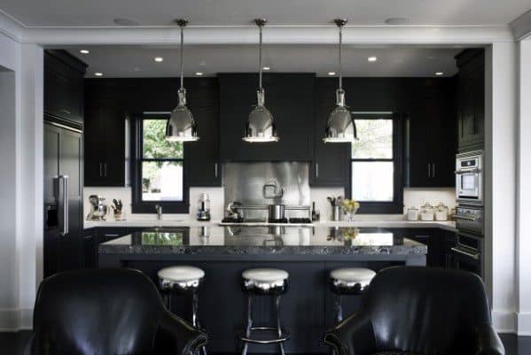 Modern black kitchen with pendant lights, island seating, and sleek cabinets