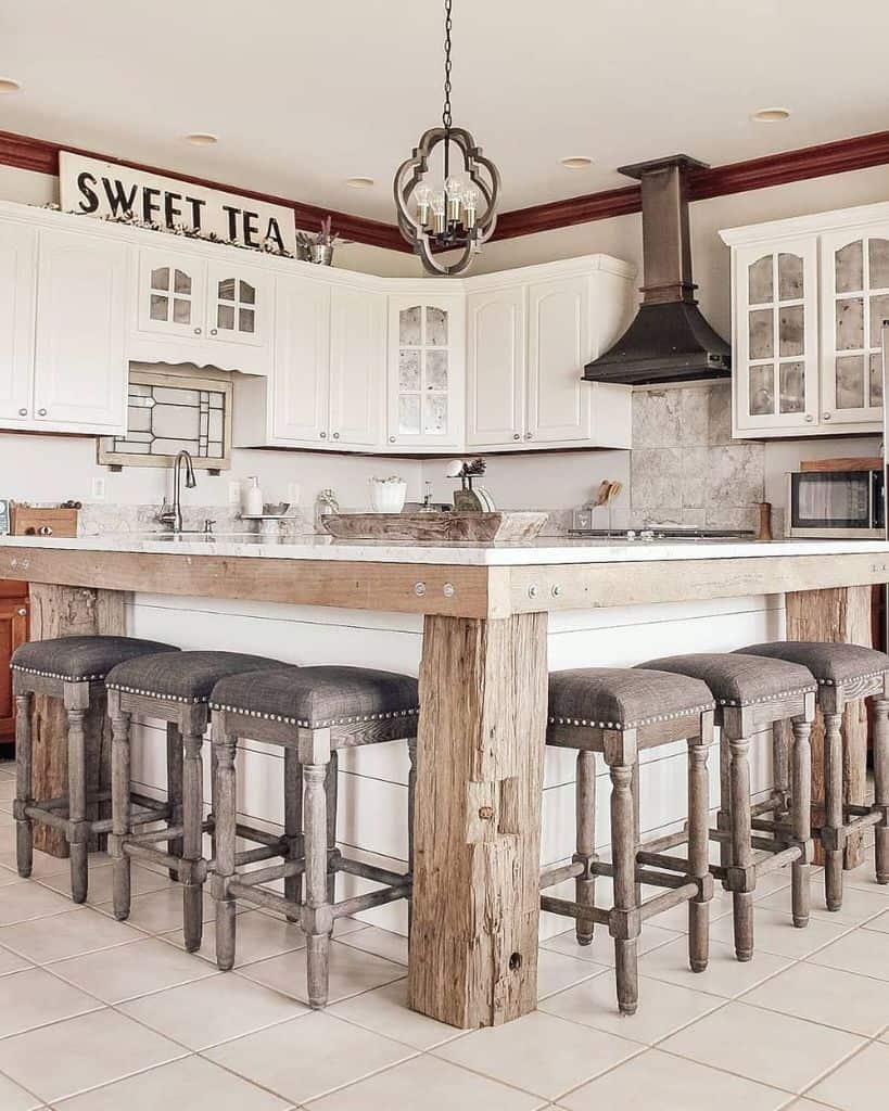 rustic country style kitchen with white cabinets and large island 