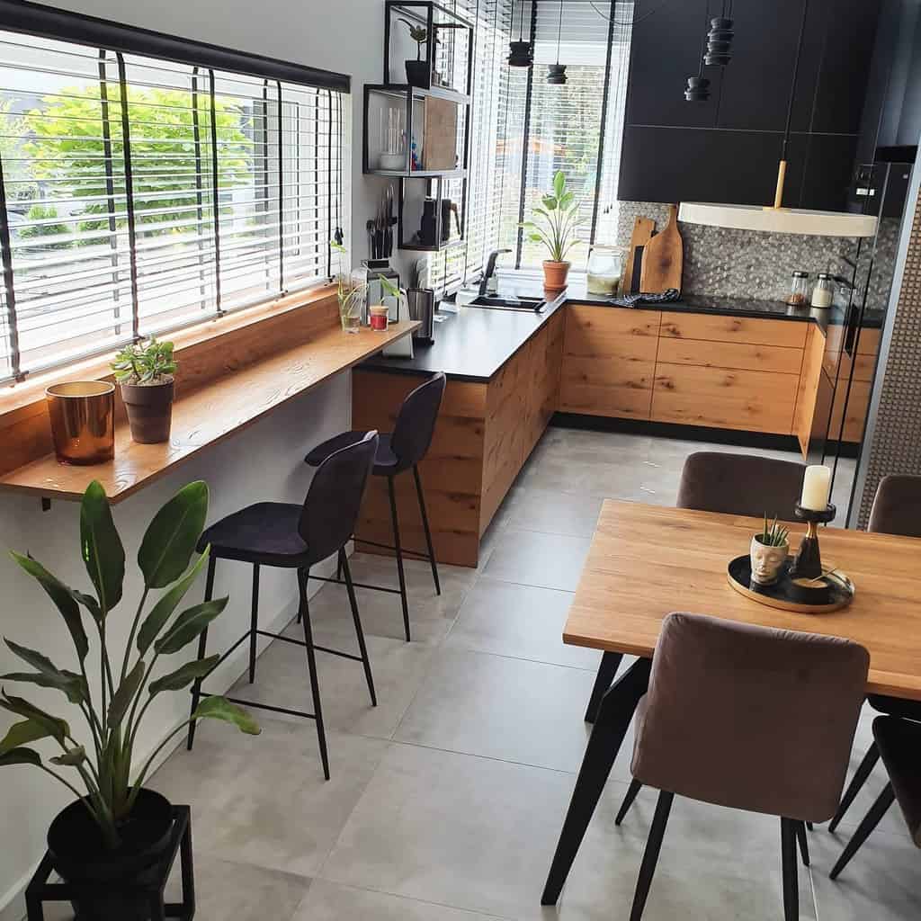 Modern kitchen with wooden cabinets, bar seating, large windows, and minimalist decor.