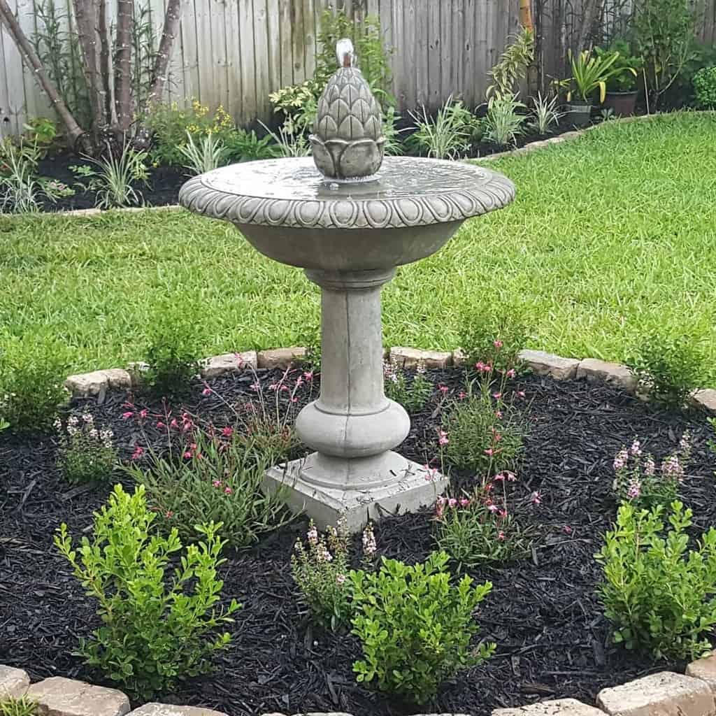 stone water fountain in small backyard 