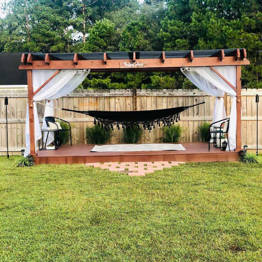 backyard wood patio hammock two chairs grass 