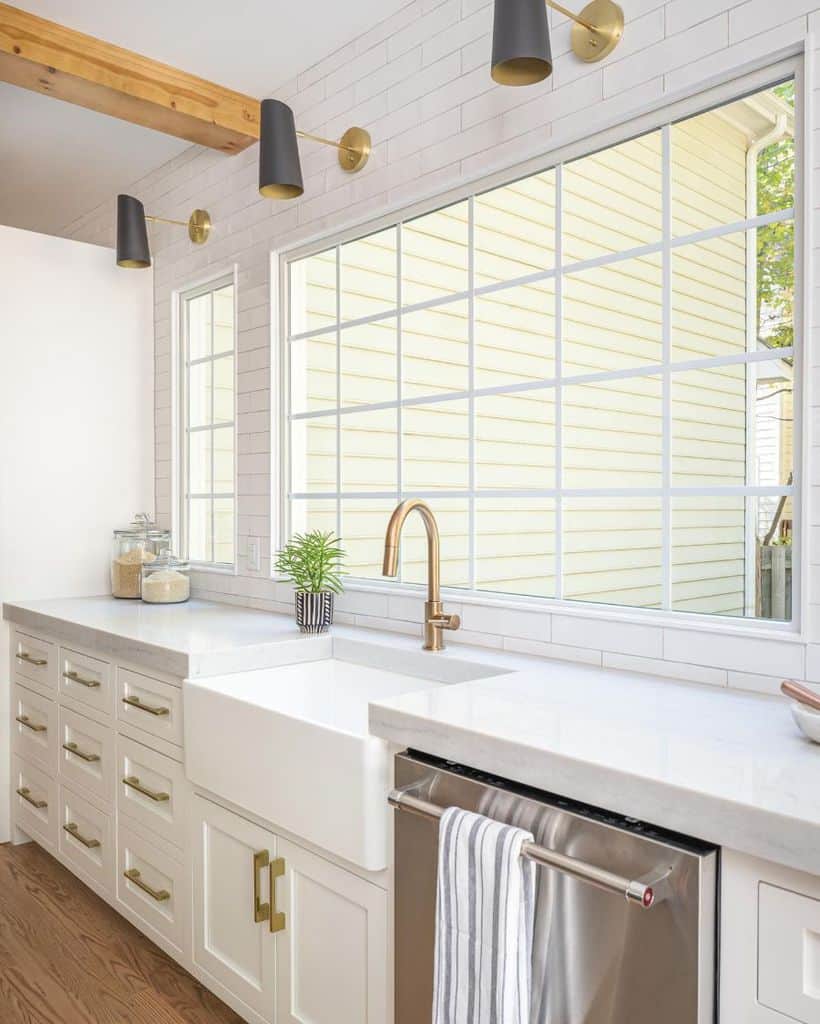 light white cabinet kitchen with gold accents and apron sink 