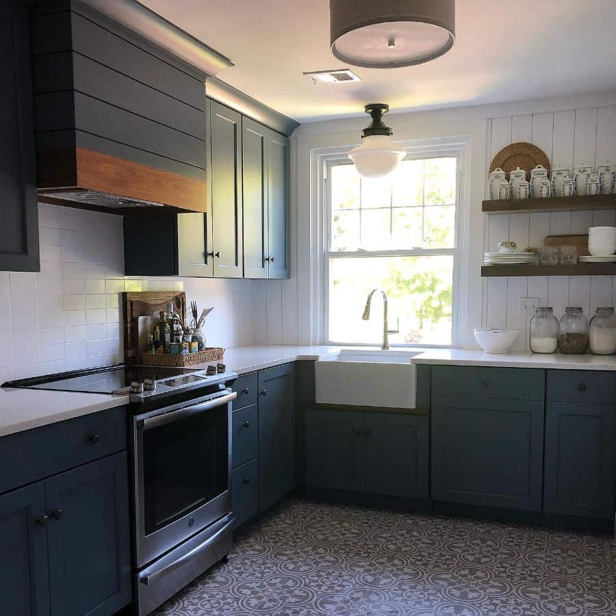 rustic kitchen with gray cabinets and pattern tile floor