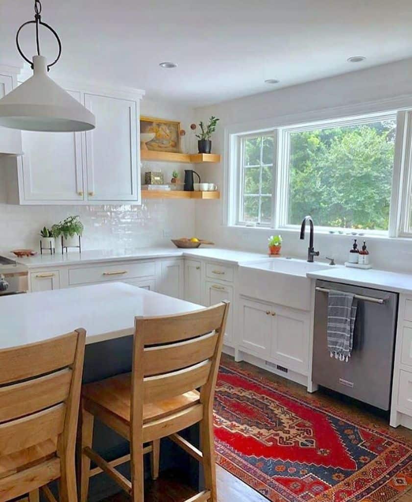 large rustic kitchen with white cabinets and gold accents 