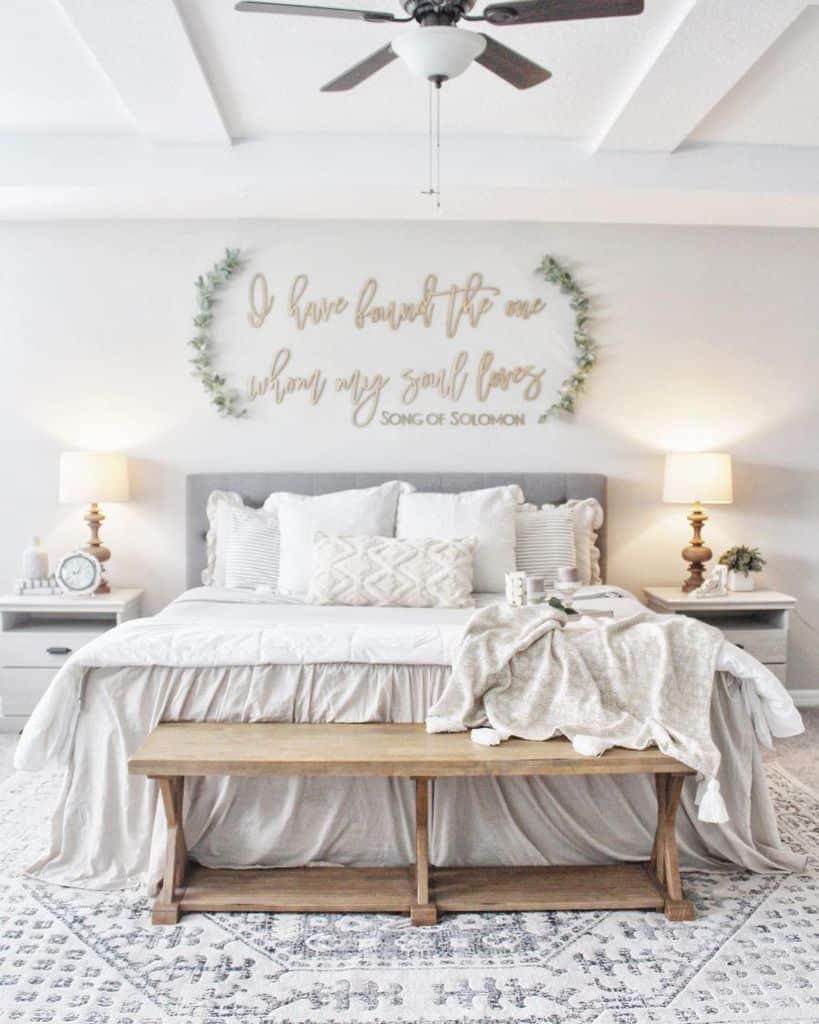 Country-style bedroom with wooden bench and "Song of Solomon" quote wall art.