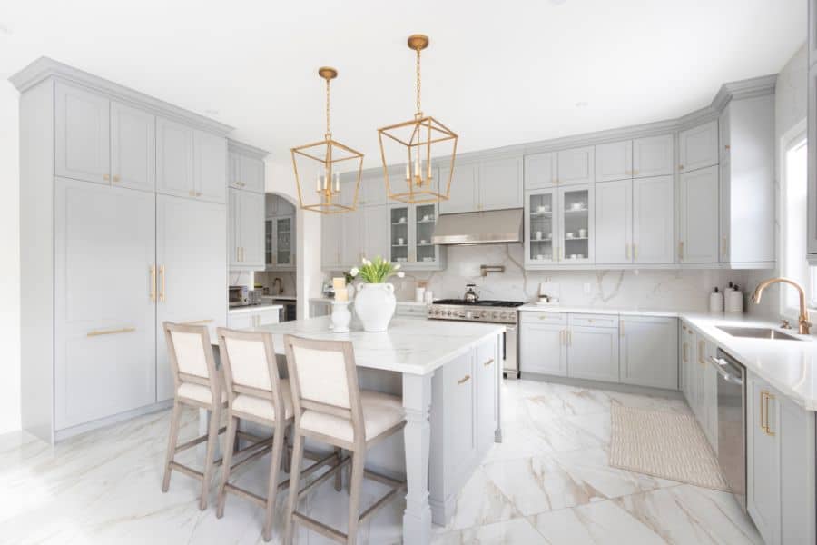 gray cabinet kitchen with gold accents and marble flooring 