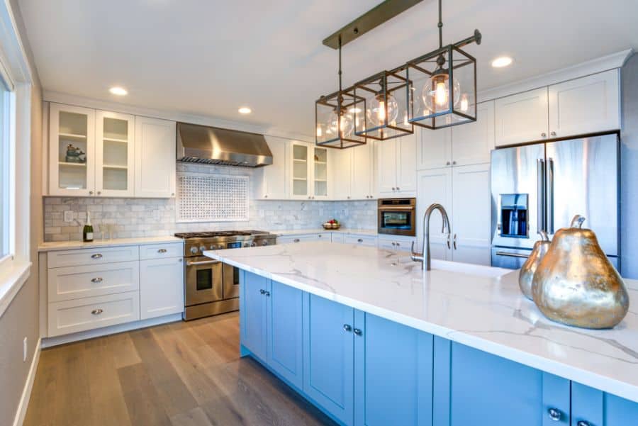 stylish white and blue cabinet kitchen with marble countertops 