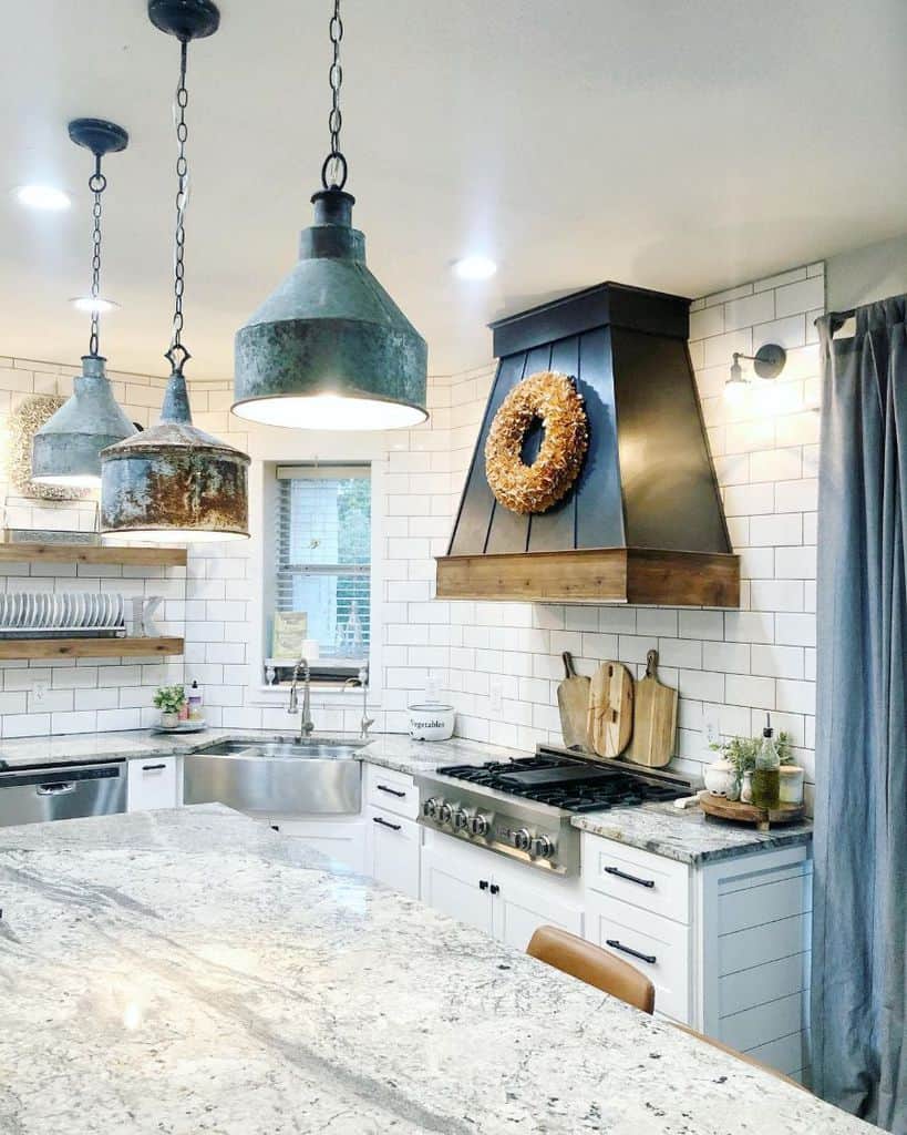 farmhouse kitchen with white tile backsplash and metal apron sink 