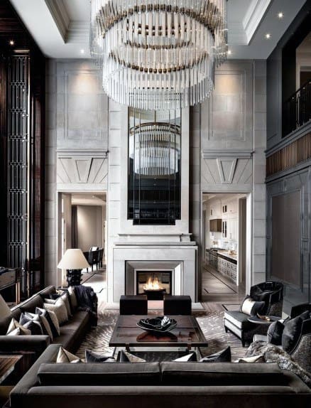 elegant formal living room gray couches high ceilings fireplace lavish chandelier