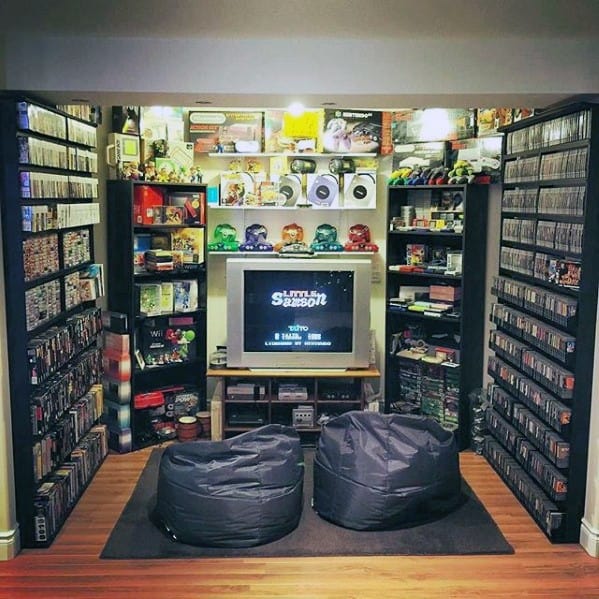 Cozy home gaming room with retro video games, consoles, and bean bag chairs in front of a CRT TV