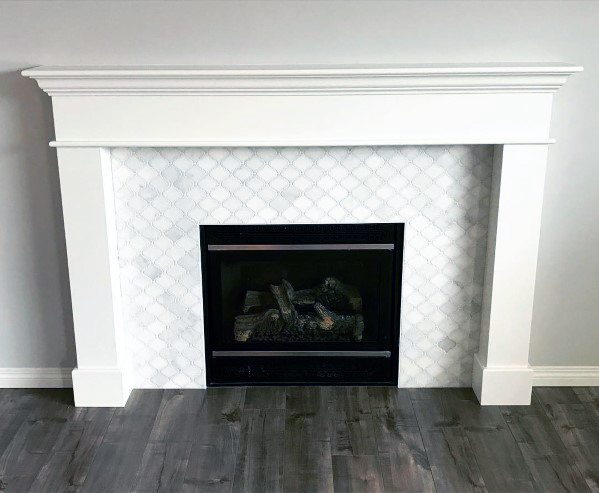 A classic white fireplace with a crisp, geometric tile surround, adding subtle elegance to the room.