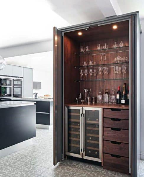 Luxury mini bar with wood interior, glass shelves, wine fridge, and pull-out drawers.