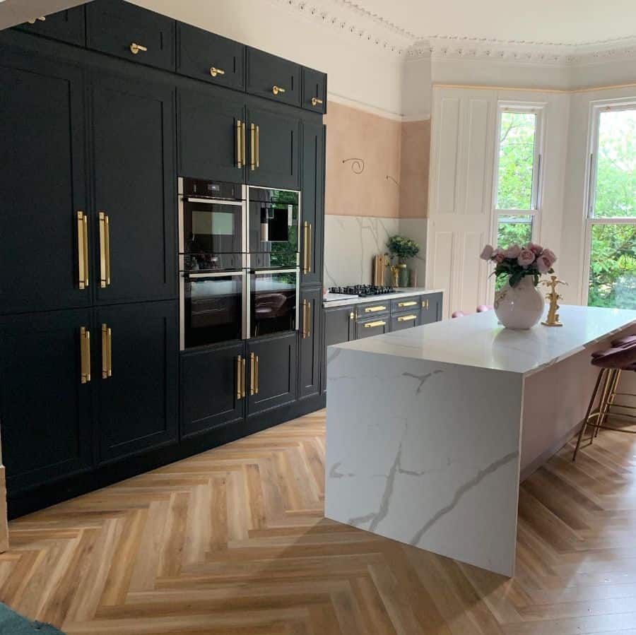 black cabinets with gold accents kitchen white marble island bar