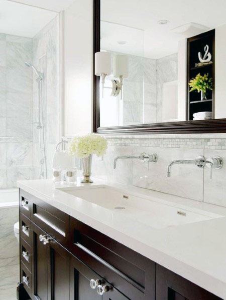 Bathroom with dark wood vanity, marble backsplash, and mosaic tile accent strip.