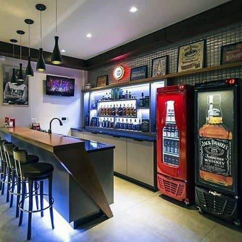 Sleek motorbike showroom with glass tables, glossy floors, and framed artwork on the walls.