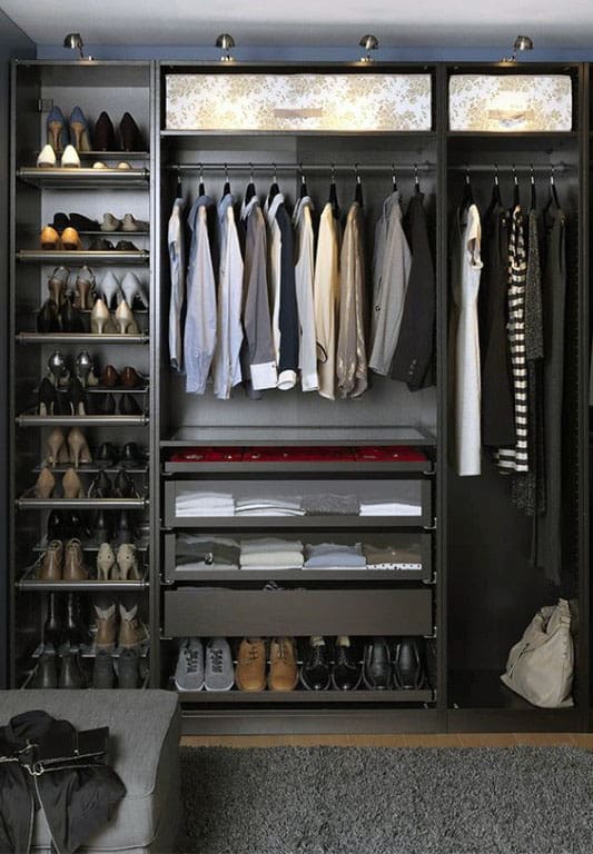 Organized closet with hanging clothes, shoes on shelves, and folded items in drawers